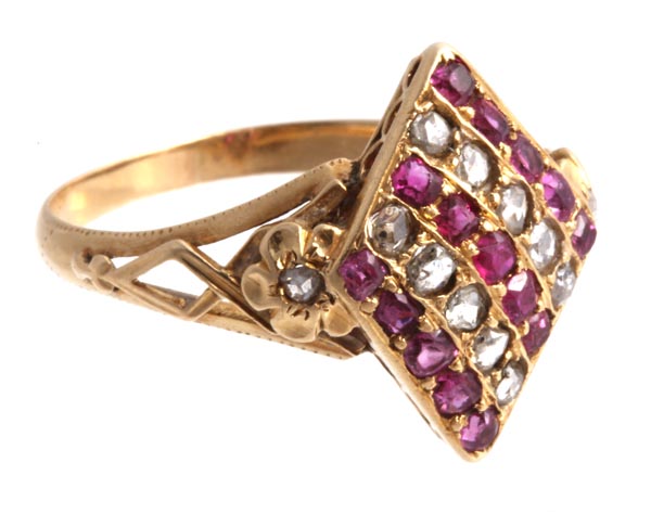 A ruby and diamond panel ring, the marquise shaped ring set with alternating lines of rubies and