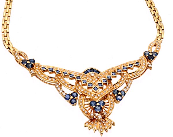 A sapphire and diamond necklace, the triangular shaped panel with pierced geometric detailing set