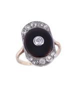 An onyx and diamond dress ring, the shaped panel with a central polished oval onyx plaque with a