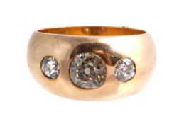 A diamond three stone gypsy ring, the central old brilliant cut diamond in a collet setting,