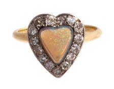 A diamond and opal heart cluster ring, the cabochon heart shaped opal within a surround of eight