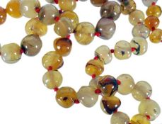 An agate bead necklace, the graduated polished agate beads on a knotted necklace, largest diameter