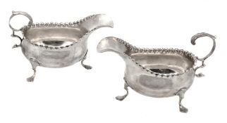 A pair of George III silver oval cream boats, maker`s mark `R. ..` (rubbed), London 1770, with