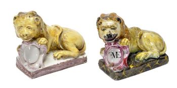 Two similar continental faience models of recumbent lions, probably French, each modelled clasping