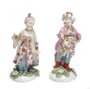 A pair of Derby figures of a Turk and companion, each modelled holding flowers, 12cm high, circa