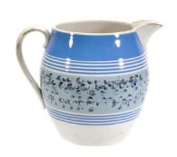 A British pottery mocha ware jug, of so called `Dutch` type, barrel-shaped with loop handle,