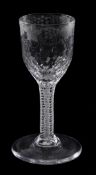 An engraved opaque-twist wine glass, the ovoid bowl decorated with a band of fruiting vine above a