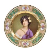 A Dresden porcelain cabinet plate painted with a maiden with roses in her hair, within an elaborate