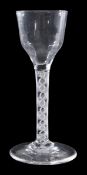 An opaque-twist wine glass, the hammered flute ogee bowl supported on a double-series stem and a