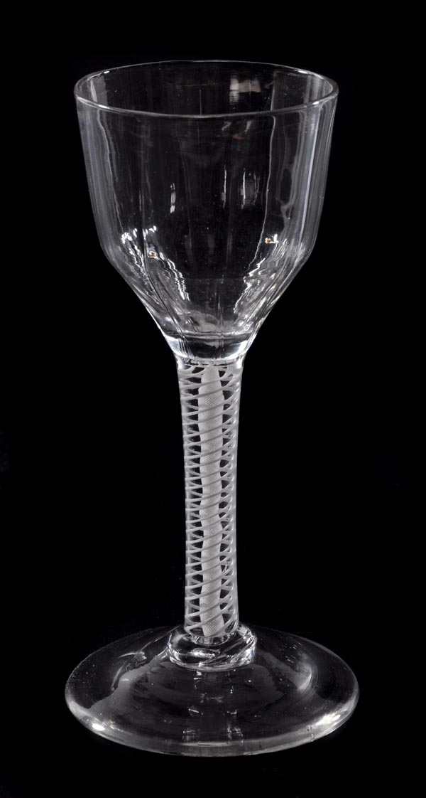 An opaque-twist wine glass, the panelled ogee bowl supported on a double-series stem and a conical
