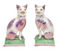 A pair of British pottery models of cats, pink-lustre decoration, 18cm high, 20th century. (see