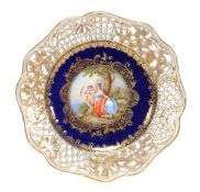 A Dresden porcelain cabinet plate with reticulated rims, the centre painted with Venus and Cupid