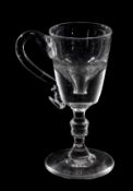 A toastmaster`s glass, the deceptive bucket bowl applied with a loop handle and supported on a