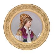 A large Vienna-style dish painted with the bust profile portrait of a woman wearing national dress,