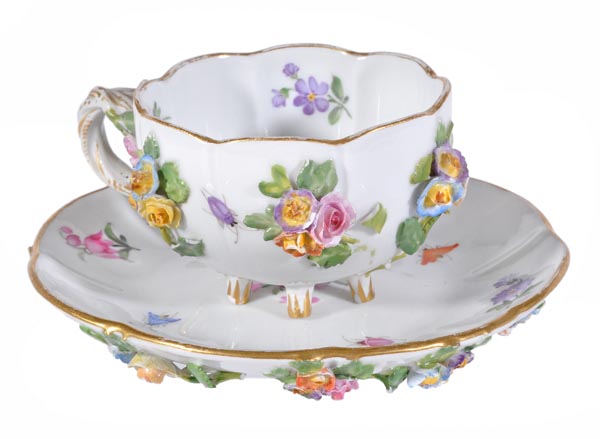 A Meissen flower-encrusted cabinet cup and saucer, typically decorated with flowers and insects,