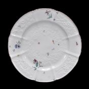 A Chelsea relief-moulded plate, decorated in low relief with floral sprays and painted in colours