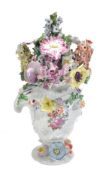 A Longton Hall flower-encrusted asymmetrical vase and cover, modelled en rocaille and painted with