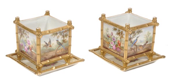 A pair of French porcelain square-section jardinieres and stands, Paris or Limoges, painted with