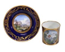 A Sevres blue ground and gilt scroll coffee can and saucer, painted with landscape panels, the can