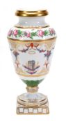 A Paris porcelain urn, richly decorated with trophies, flowers and swags, 29cm high, circa 1830