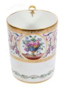 A Paris porcelain Sevres-style mug, decorated with a round panel of an urn issuing flowers reserved