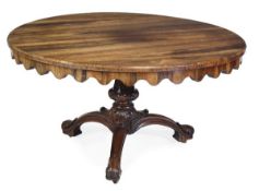 A Regency rosewood circular centre table, circa 1815, the top with shaped frieze, on a fluted and