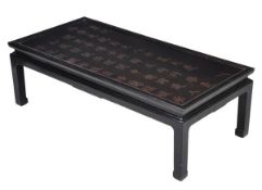 A Chinese black lacquered occasional table, 20th century, the top inscribed and parcel gilt