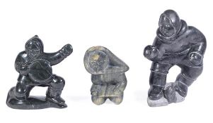 Three Innuit sculpted stone models of fishermen, late 20th century, the first with a fish rising