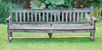 A Victorian oak garden bench, circa 1875, almost certainly designed by Richard Norman Shaw, the