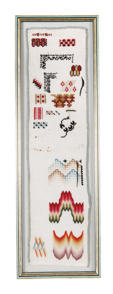 A woolwork sampler of linen, mid 19th century, with isolated patterns and designs worked in