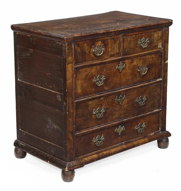 A George I walnut chest of drawers, circa 1720, with stringing, two short and three long drawers on