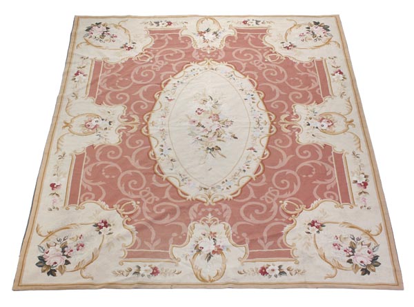 An Aubusson woven carpet, 20th century, with central floral motif within a cream coloured oval