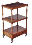 A George IV mahogany three tier whatnot, circa 1825, with turned supports, a drawer to the base and