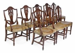 A set of eight mahogany and leather upholstered dining chairs in George III style, 20th century, to