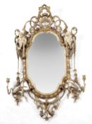 A Continental giltwood and composition mirror, late 18th/early 19th century, with a pierced crest,