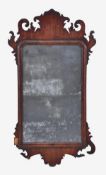 A George II mahogany fret frame wall mirror, circa 1740, pierced scrolling frame, moulded borders,