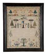 A needlework sampler, by Ann Childs, early 19th century, designed with Christ on the Cross between