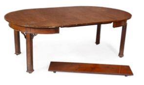 A mahogany extending dining table, circa 1900, the circular top extending with three additional