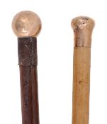 A gold mounted malacca walking stick, early 20th century, the hallmarked 9 carat knob grip engraved