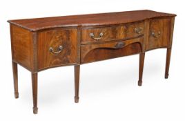 A mahogany serpentine fronted sideboard, in George III style, 20th century, the shaped top with