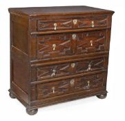 A Charles II oak chest of drawers, circa 1660, in two sections, rectangular top, four long drawers,