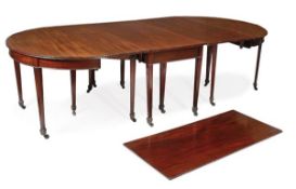 A George III mahogany extending dining table, circa 1800, incorporating a pair of D-shaped ends and