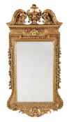 A carved giltwood wall mirror, circa 1740 and later, the rectangular plate within a moulded frame