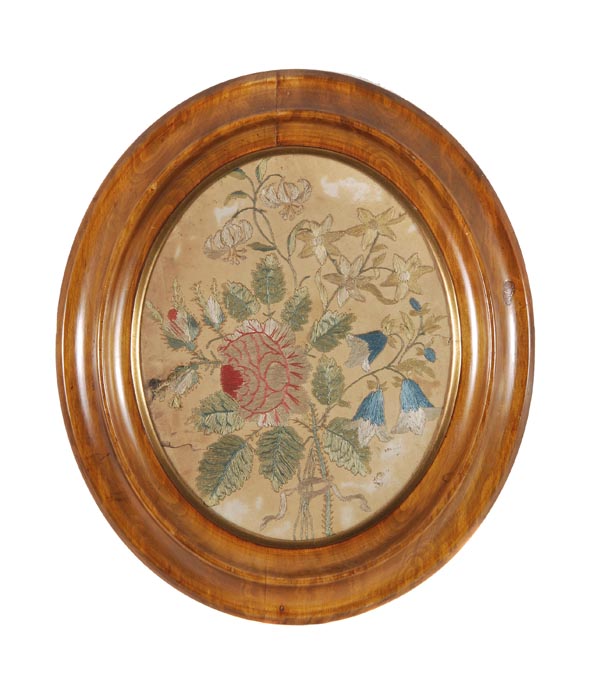 An oval embroidered picture, late 19th century, designed with a bouquet of flowers, worked in