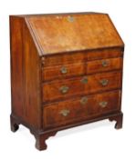 A George II walnut and holly strung bureau, circa 1740, rectangular hinged fall opening to an