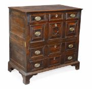 An oak and walnut chest of drawers, second half 17th century, the front panelled and moulded with