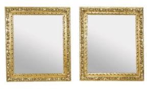 A pair of carved giltwood framed wall mirrors, 19th century and later, each rectangular plate