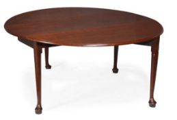 A George II mahogany drop leaf dining table, circa 1750, oval top with moulded edge incorporating a