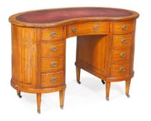 An Edwardian satinwood and tulipwood crossbanded kidney shaped desk, circa 1910, shaped top with