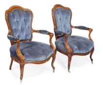 A pair of Victorian walnut armchairs, circa 1880, shaped backs, open arms, bowfront seat, on